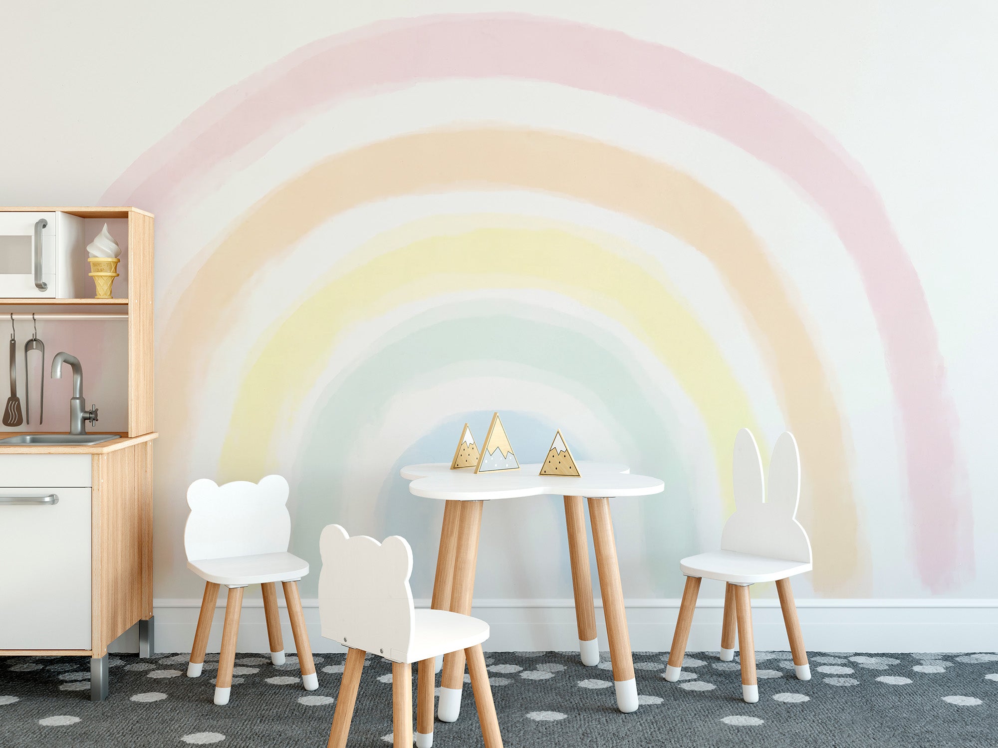 Brighten kids rooms with the soft glow of a pastel rainbow mural