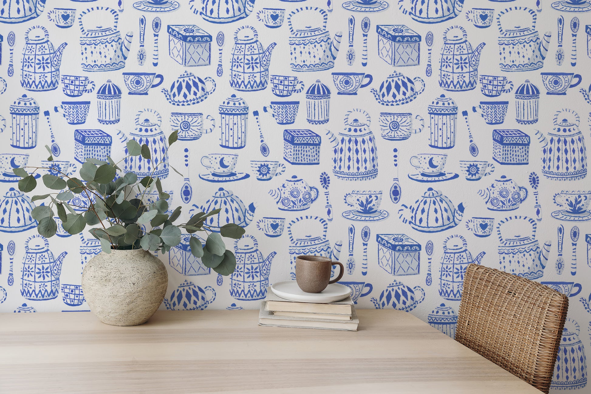 Elegant tea set in blue wallpaper for a calming kitchen vibe.
