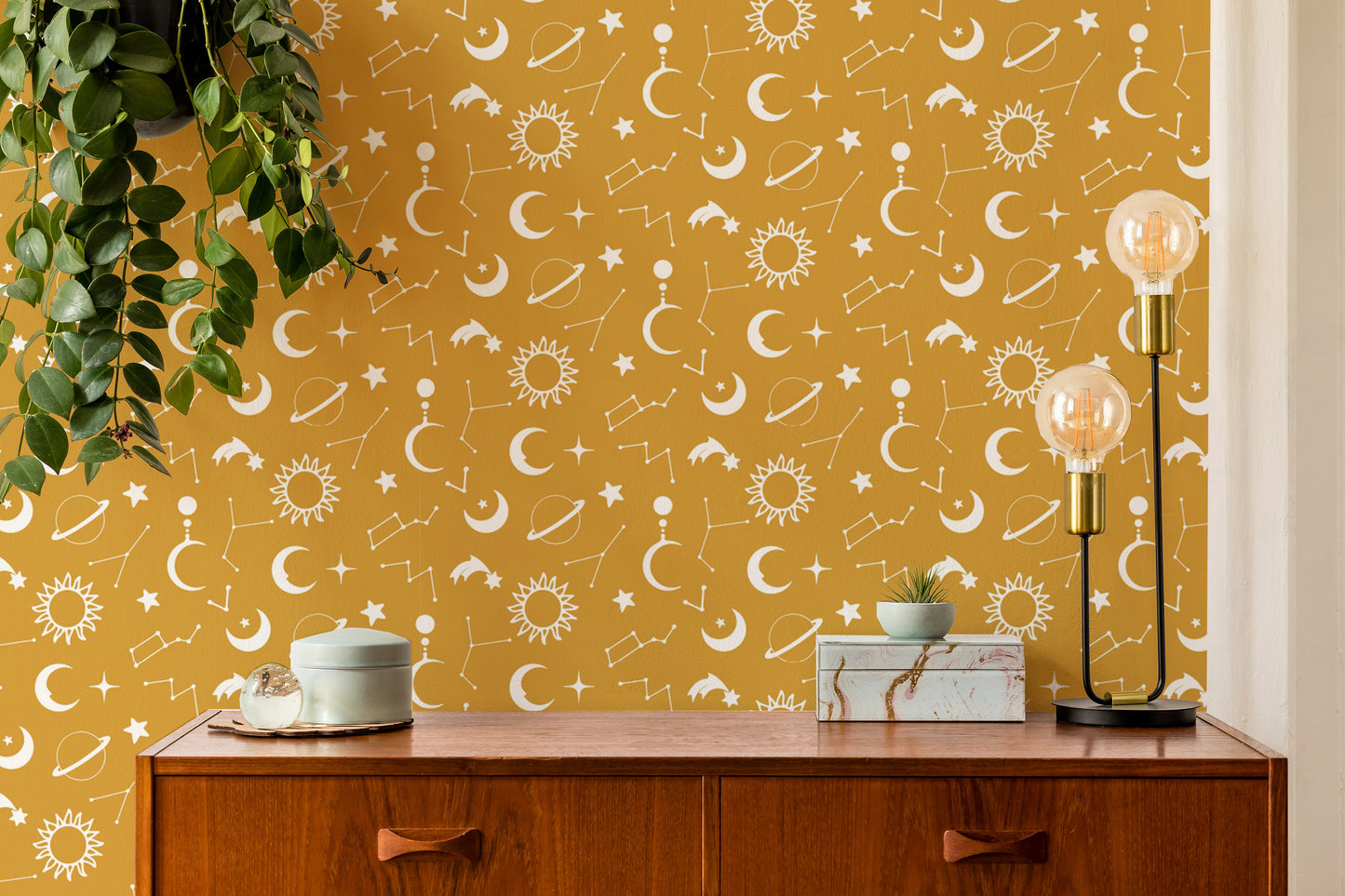 Celestial yellow wallpaper with moons and stars
